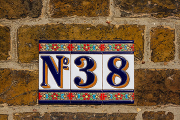 House number 38 on colorful tiles