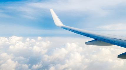 Fototapeta na wymiar Cloudscape with airplane wing
