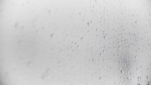 Close up of rain drops on the window, shallow depth of field.