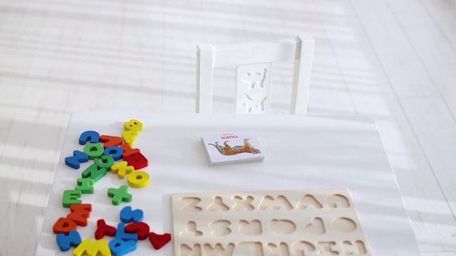 colorful wooden alphabet letters with educational flashcard are on the table