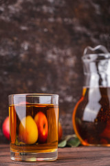 Glass of apple juice on wooden table. Fruit drink. Copy space