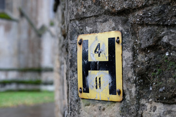 Shallow focus of a typical water Hydrant sign seen attached to a stone wall located near a famous...
