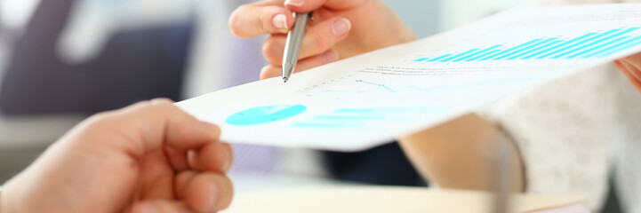 Female hand showing financial report paper to customer