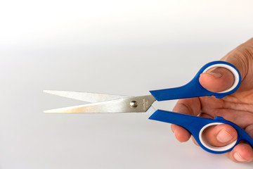 Hand hold scissors on white background