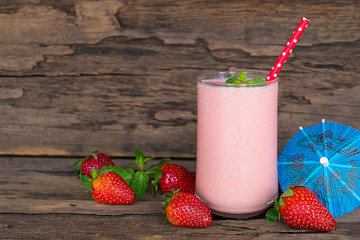 Strawberry yogurt fruit juice smoothie pink colorful fruit juice milkshake blend beverage healthy high protein the taste yummy In glass drink episode morning on wood background.