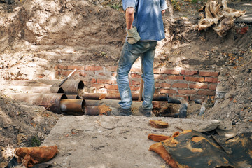 worker replacing underground heating main pipes