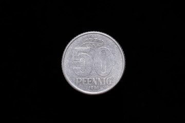 Old German Democratic Republic 50 Pfennig coin from 1958, reverse. Isolated on black background