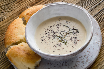 almond cream soup decorated with fried rosemary and sumac served with lavash pieces