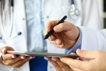 Male GP making electronic notes in tablet pc