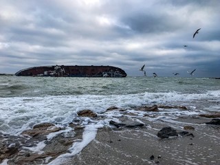 old ship sunken at sea near the shore