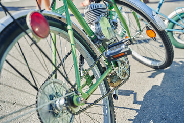 Fototapeta na wymiar Close-up of a bike with a home-made retro engine. retro moped
