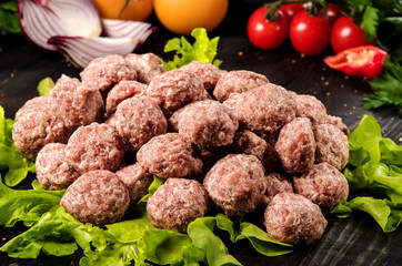 raw pork meatballs with lettuce and vegetables