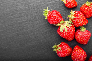 ripe strawberries on a black background