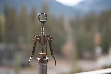 Wine opener pulling a cork out of a wine bottle