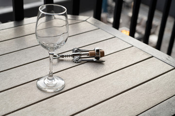 Wine glass and wine opener on a table