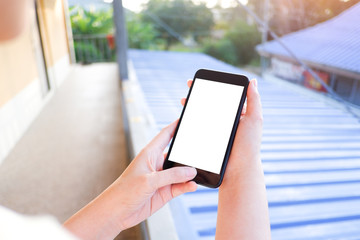 Cropped shot view of business woman’s hands holding the mobile phone with blank copy space screen for your information content or text message, the woman reading text message on the smart phone during
