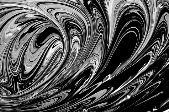 Abstract black oil and white ink color liquid viscous background. Waves and streaks acrylic paint pattern