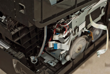 The printer is disassembled into parts. Broken, dirty and dusty printer. Service center for...