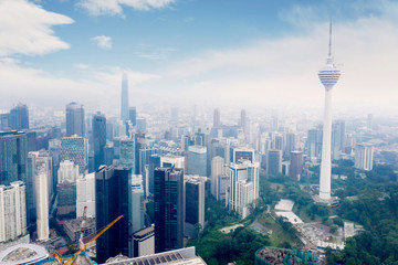 Obraz premium KUALA LUMPUR - Malaysia. November 12, 2019: Aerial view o TRX Tower and KL tower in Kuala Lumpur CBD area shot at midday over blue sky
