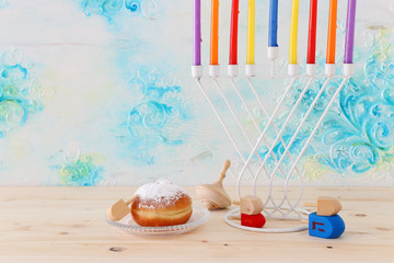 religion image of jewish holiday Hanukkah background with menorah (traditional candelabra), spinning top and doughnut