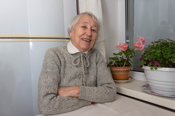 Portrait of smiling senior woman, looking at camera.