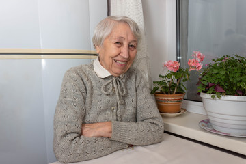 Portrait of smiling senior woman, looking at camera.