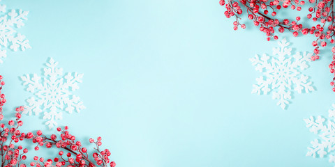 Christmas holiday composition. White branches, decoration, red berry on pastel blue background....