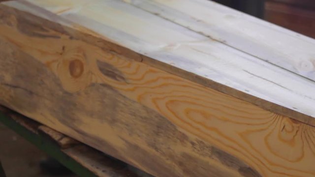 The carpenter works on a circular saw and an electric planer and makes blanks for the manufacture of coffins 17