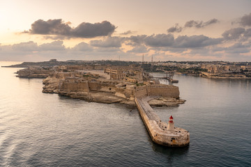 view on lighthouse of valetta at sunset, malta - obrazy, fototapety, plakaty