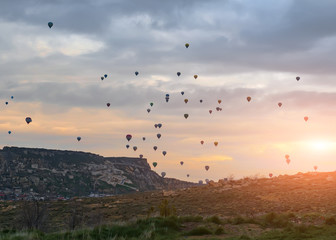 Rise sets of balloons in the early morning on sunrise background. Turkish Cappadocia.