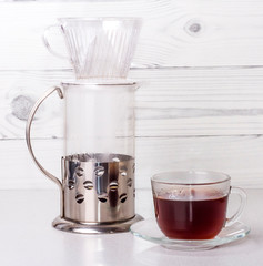 ready coffee in a transparent glass Cup, brewed in an alternative way in a funnel v60