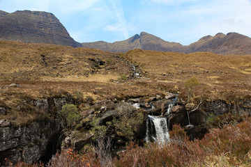 Waterfall cascades down the side of the Torridon mountain range on the west coast of Scotland