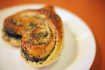 Valentine bun for breakfast for lovers on orange table background