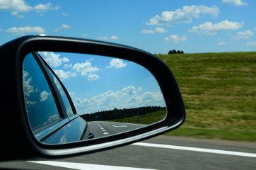Fototapeta premium Car mirror on the road