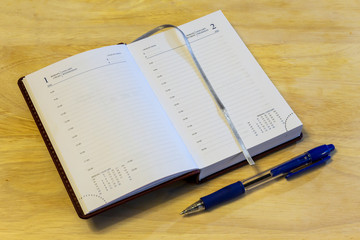 Russian-English datebook and pen lying on the surface of the table. The datebook is open on the first of January. Russia.