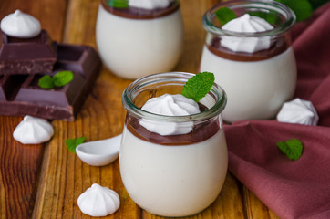 Traditional Italian dessert panna cotta with chocolate sauce and crispy meringue, dessert for...