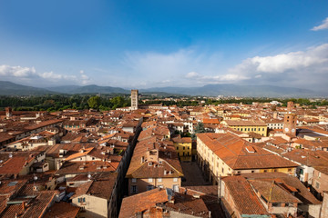 Lucca cityscape, view across rooftops toward mountains