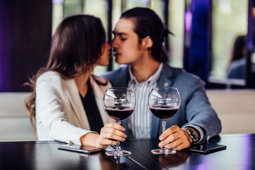 Portrait of red wine  on table while couple sitting in restaurant.