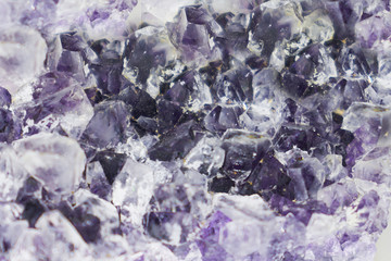 Background made of mineral. Purple amethyst crystal surface, close up