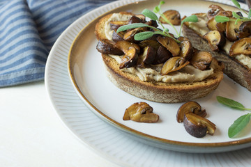 Obraz na płótnie Canvas Food photography of a crostini toasted bread with sautéed mushrooms on mushroom paté