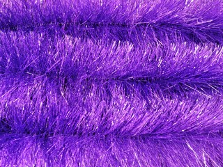 Christmas traditional decorations colorful tinsel with selective focus. Christmas background. Fluffy sparkle tinsel for Christmas tree decoration. New year background with shimmer tinsels