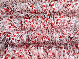 Christmas traditional decorations colorful tinsel with selective focus. Christmas background. Fluffy sparkle tinsel for Christmas tree decoration. New year background with shimmer tinsels