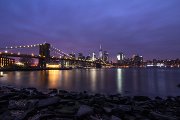 Sunset over Manhattan in New York City with a view on the Brooklyn Bridge.
