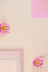 flatlay floral pink peach pastel gerbera flower leaves petals cards wedding invitation top view