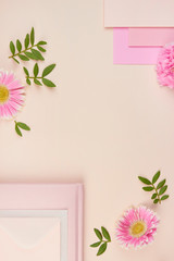 flatlay floral pink peach pastel gerbera flower leaves petals cards wedding invitation top view