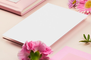 white paper mockup on peach background flower petal floral feminine pastel rose pink planner book envelope paper