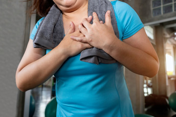 Senior woman fat Asian heart attack during training at fitness gym.