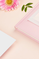 white paper mockup on peach background flower petal floral feminine pastel rose pink planner book envelope paper