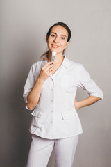 Portrait of a beautician in white uniform.