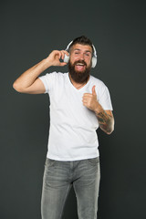 Modern headphones concept. Man mature handsome listening music headphones gadget. Singing lyrics....